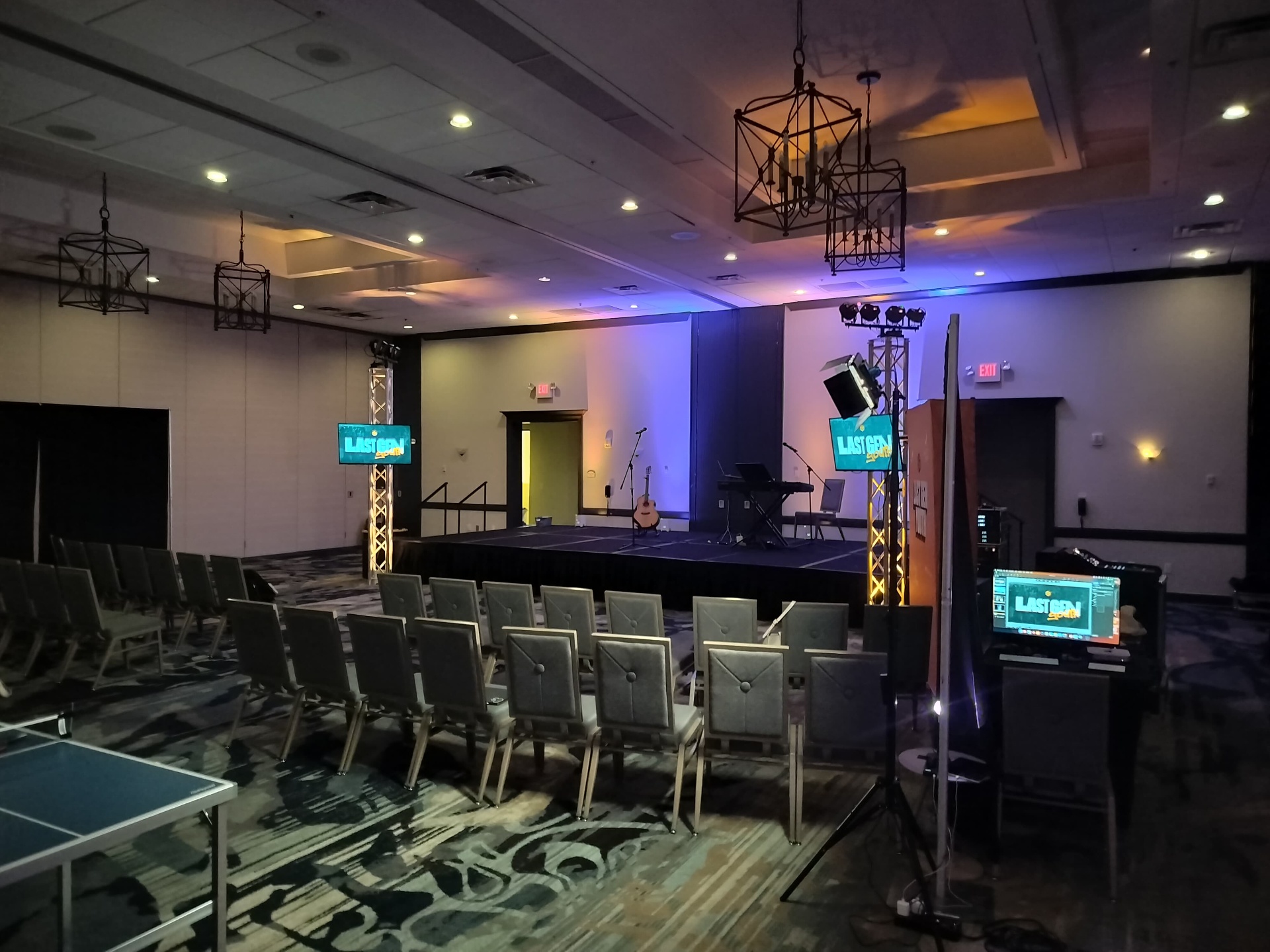 Church conference stage setup with truss lighting and uplighting