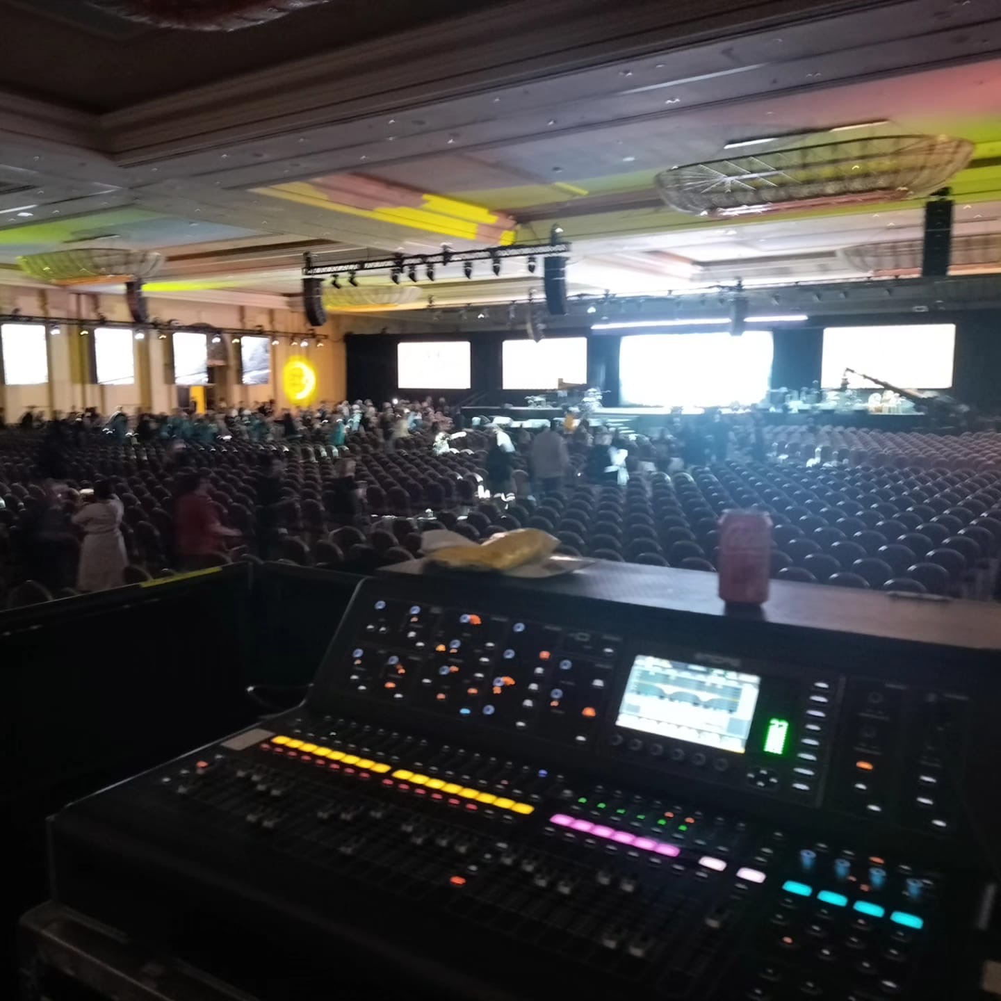 FOH mixing console facing massive theater audience