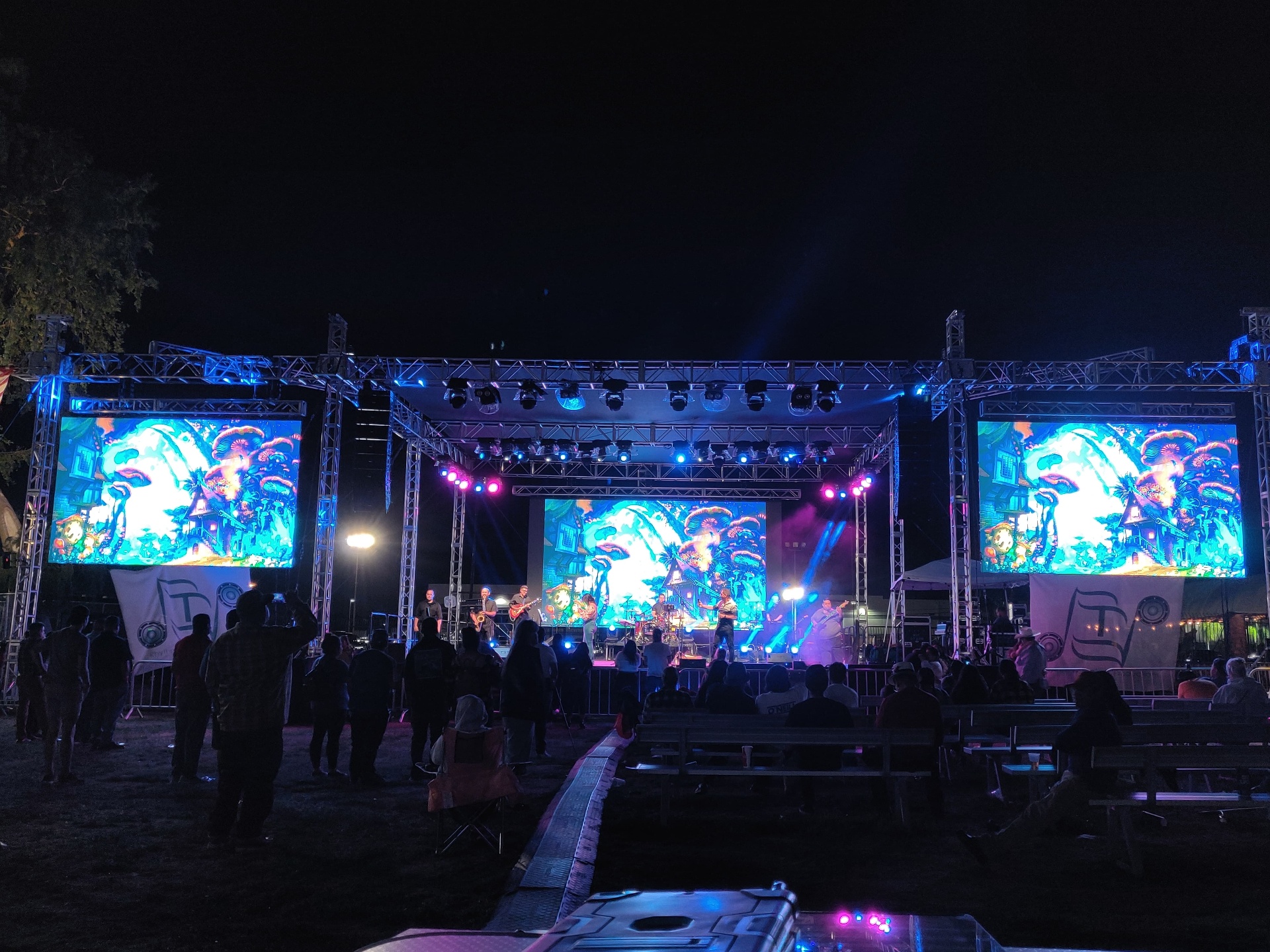 Night festival stage with massive LED video walls and full lighting rig